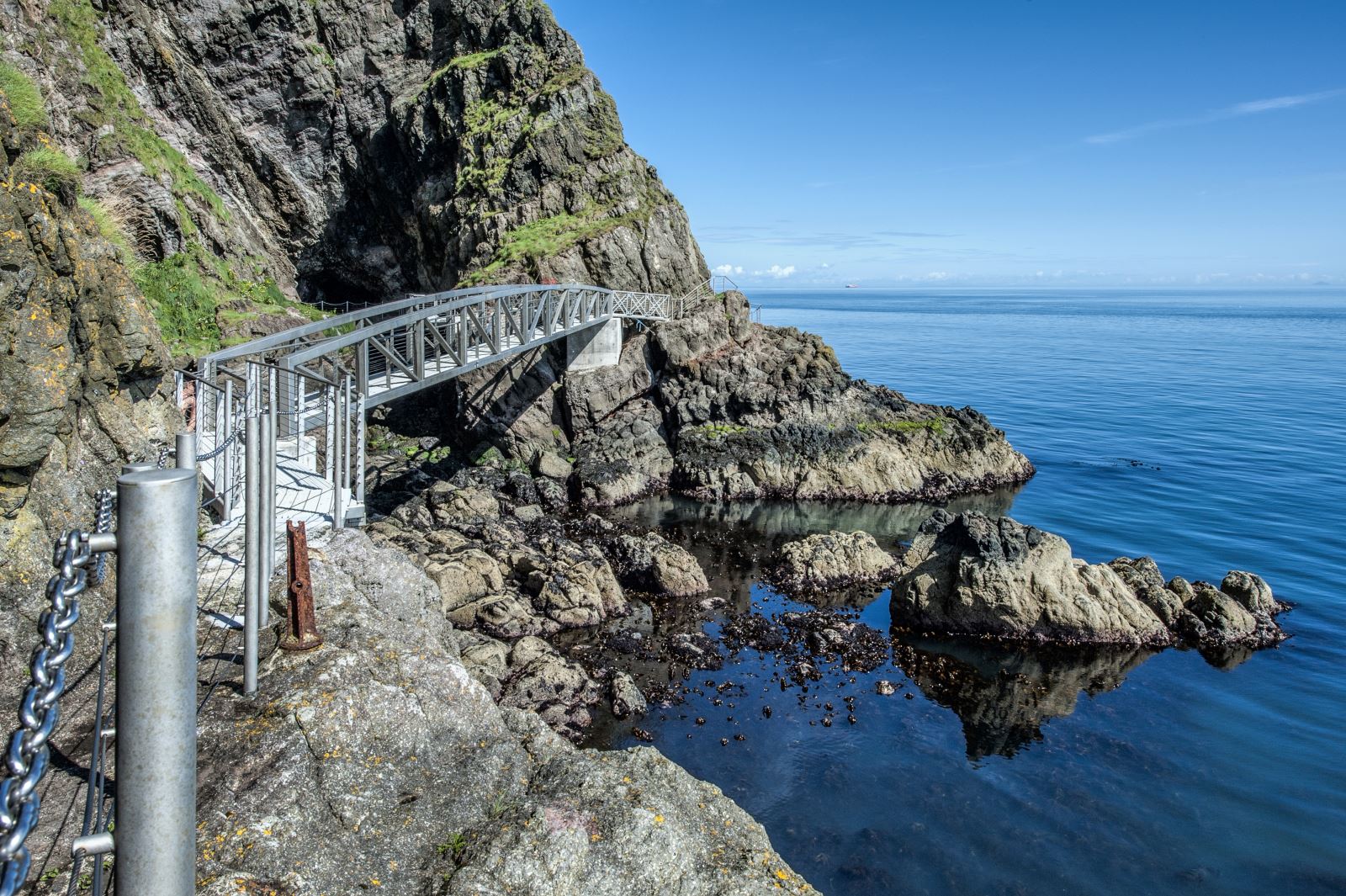One of the bridges over a cove at The Gobbins on a sunny day